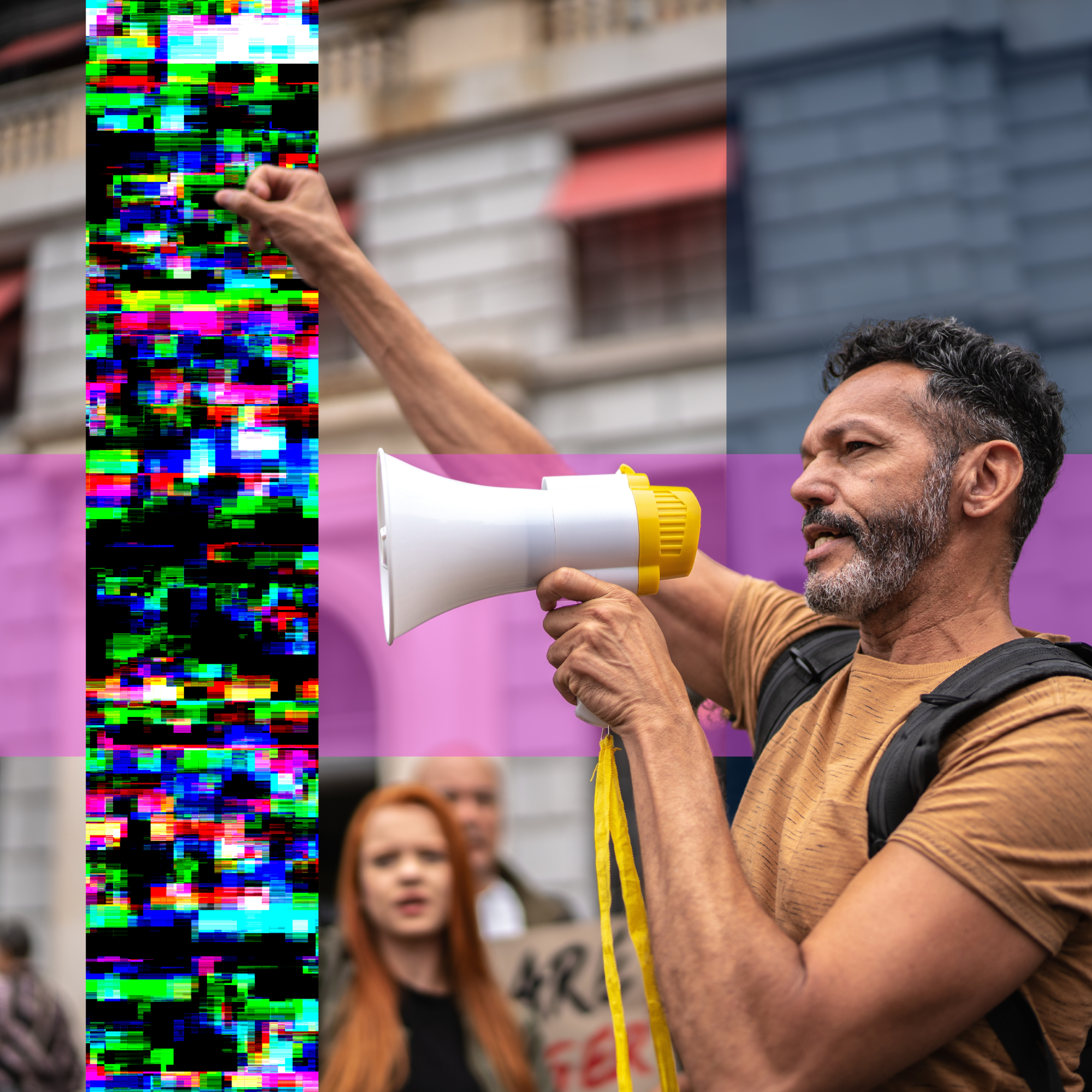 A man holding a megaphone addressing the crowd