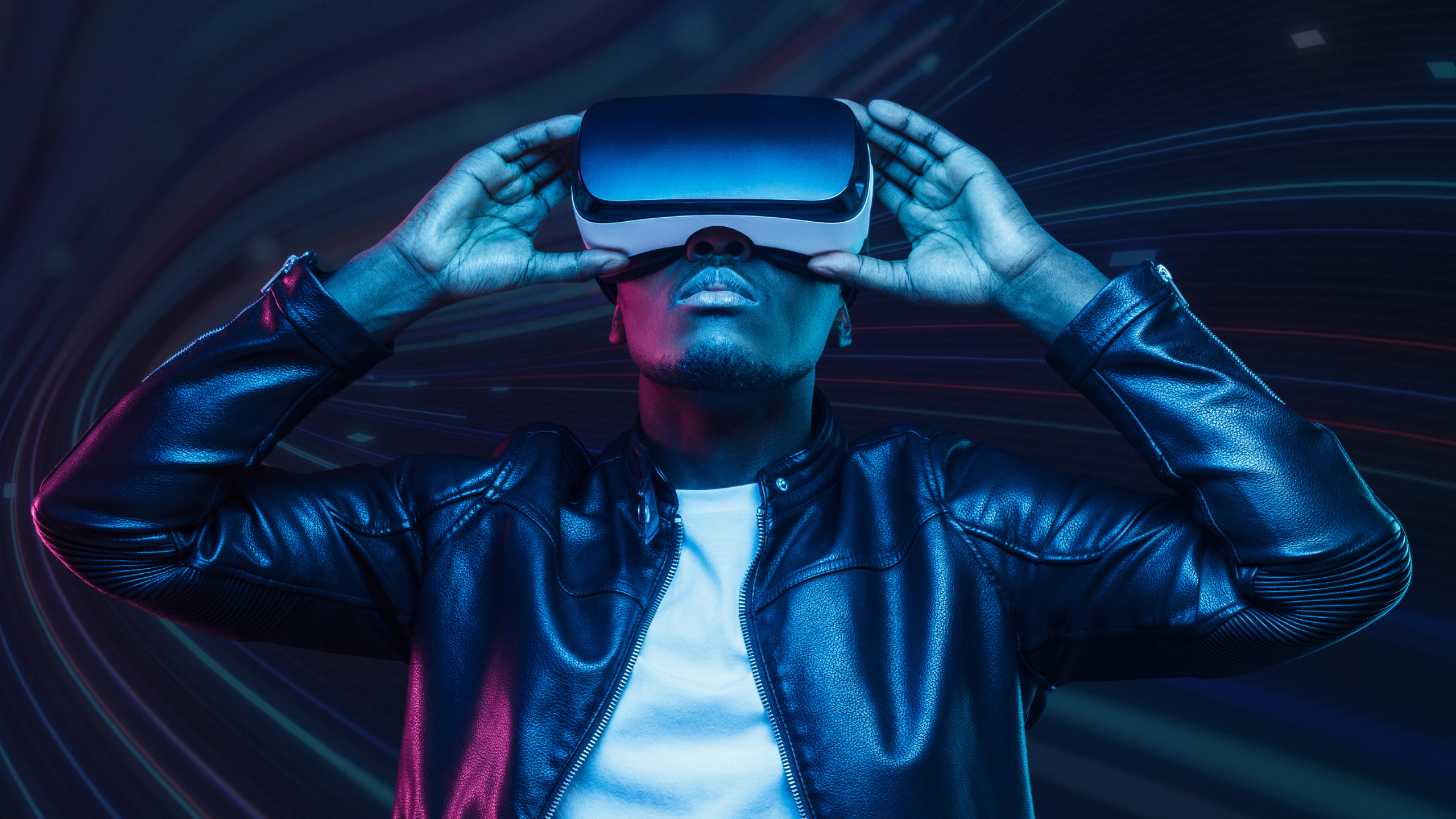 A man wearing virtual reality glasses stares into the distance