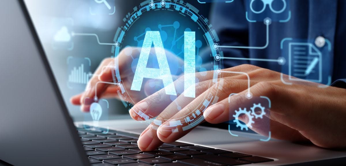 Hands type over a keyboard as the letters AI appear above the screen