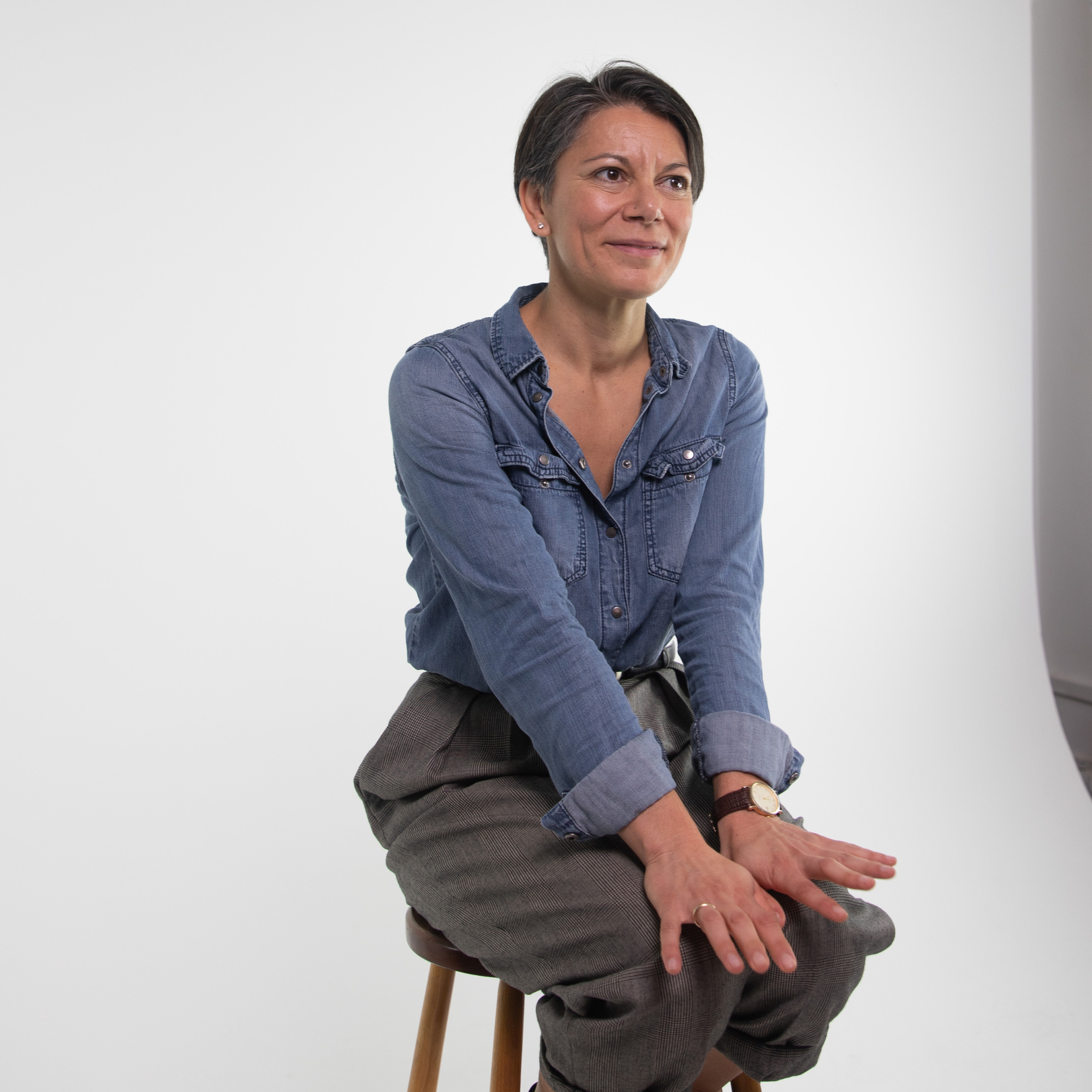 Associate Professor Angeliki Kerasidou sits in front of a white backdrop