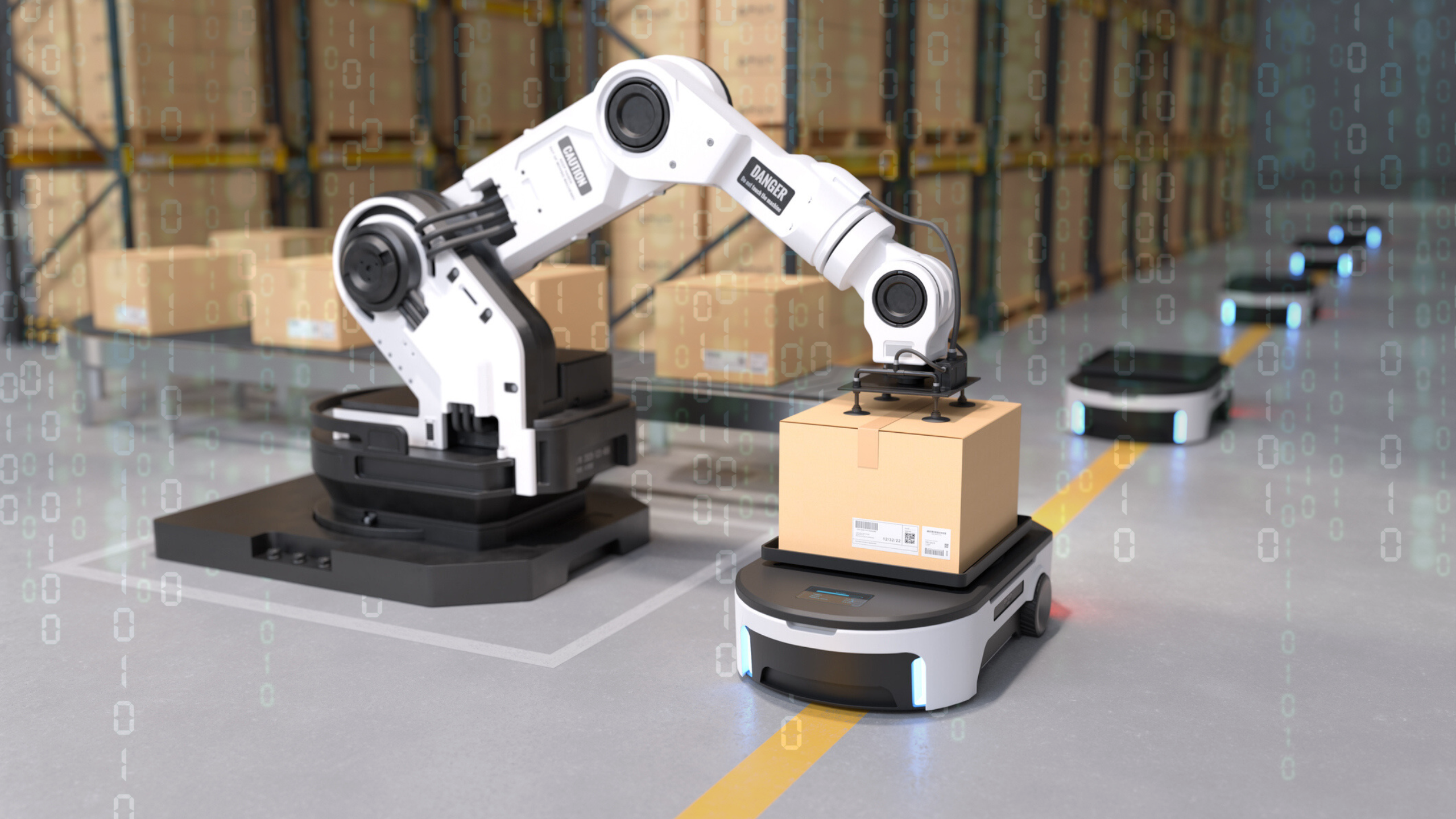 A robotic arms loads a box onto a smaller transportation robot in a factory