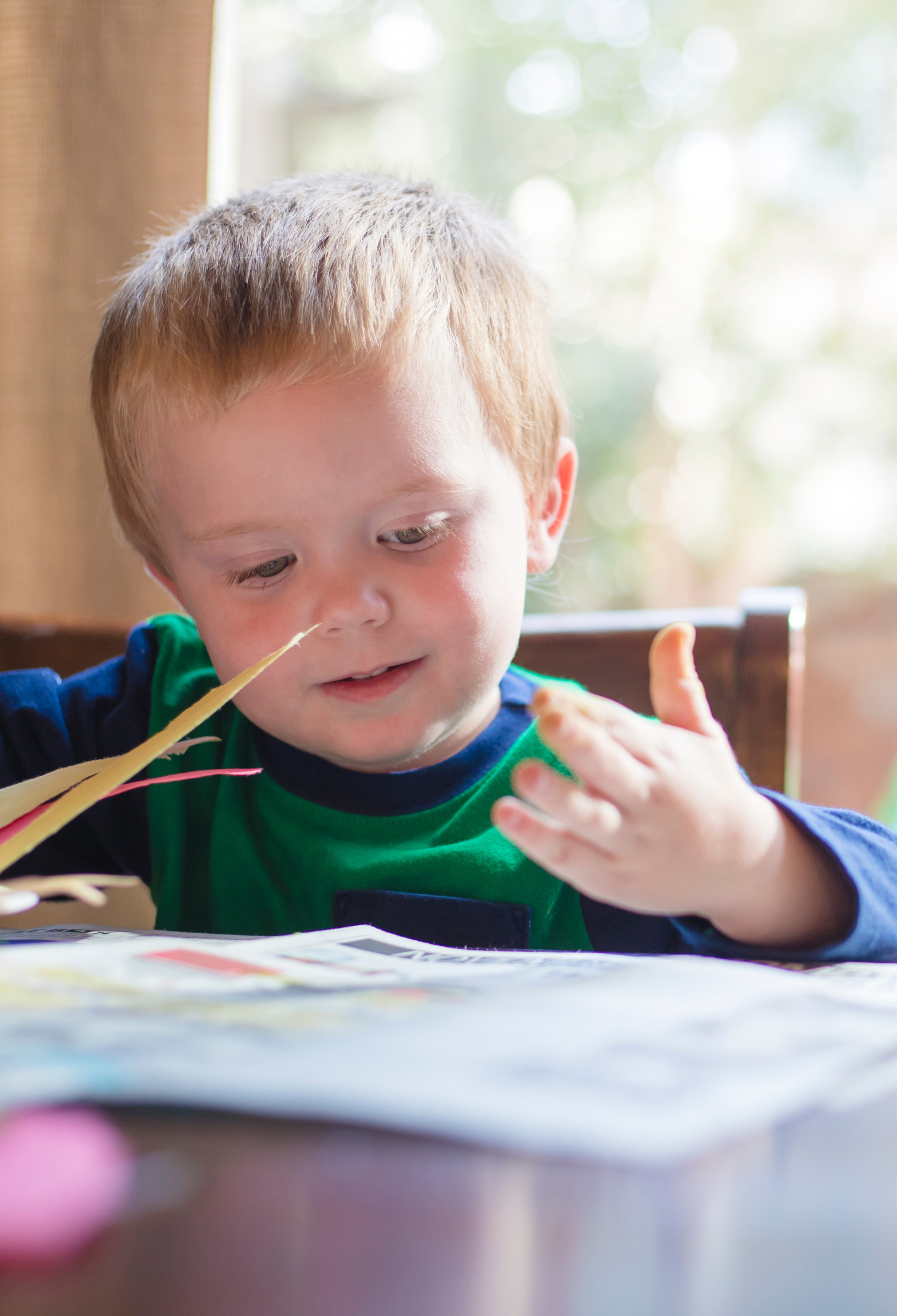 A young child flicking through books