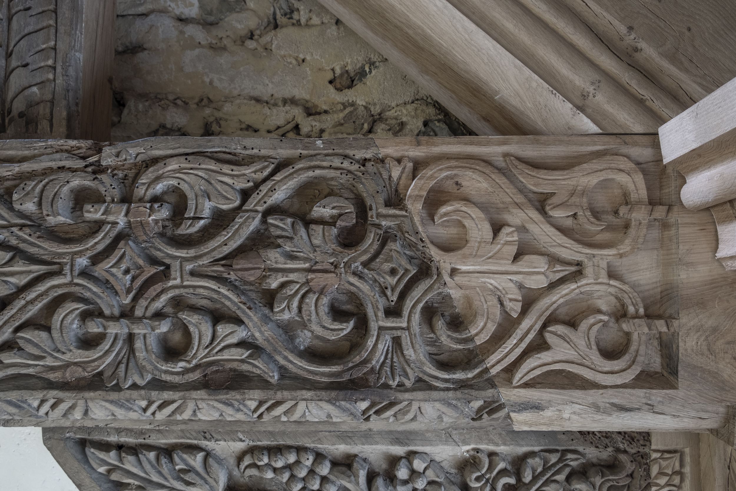 New wood has been blended into the old wooden carvings in Little Stonham Church's exposed beams.
