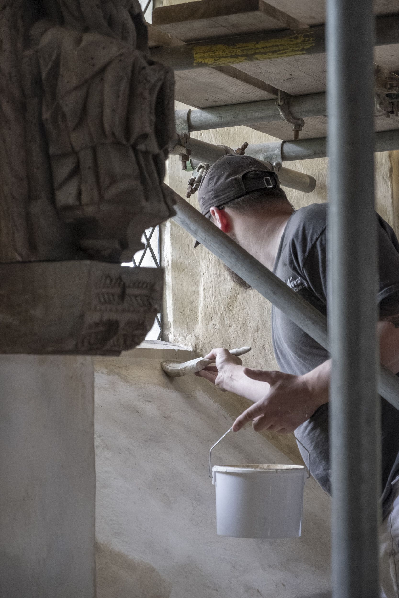 A contractor painting in the Little Stonham Church loft.