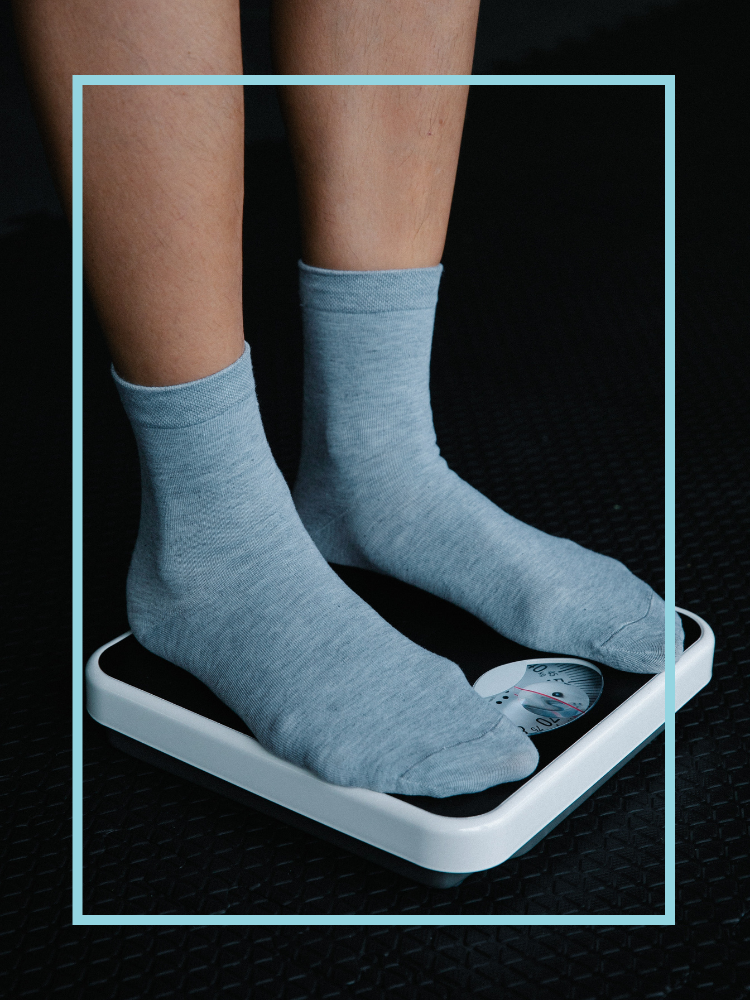 Someone in blue socks standing on a scale