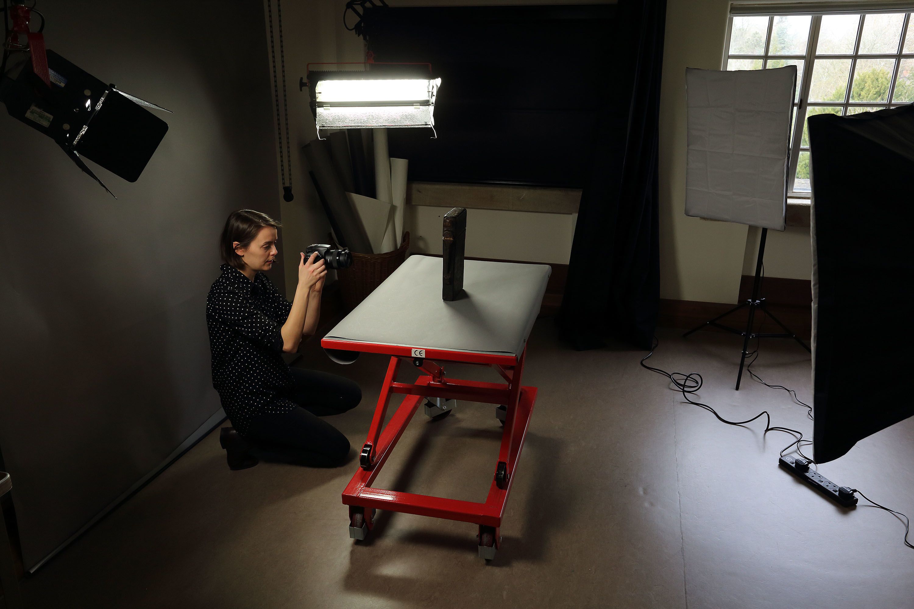 A woman photographing a book