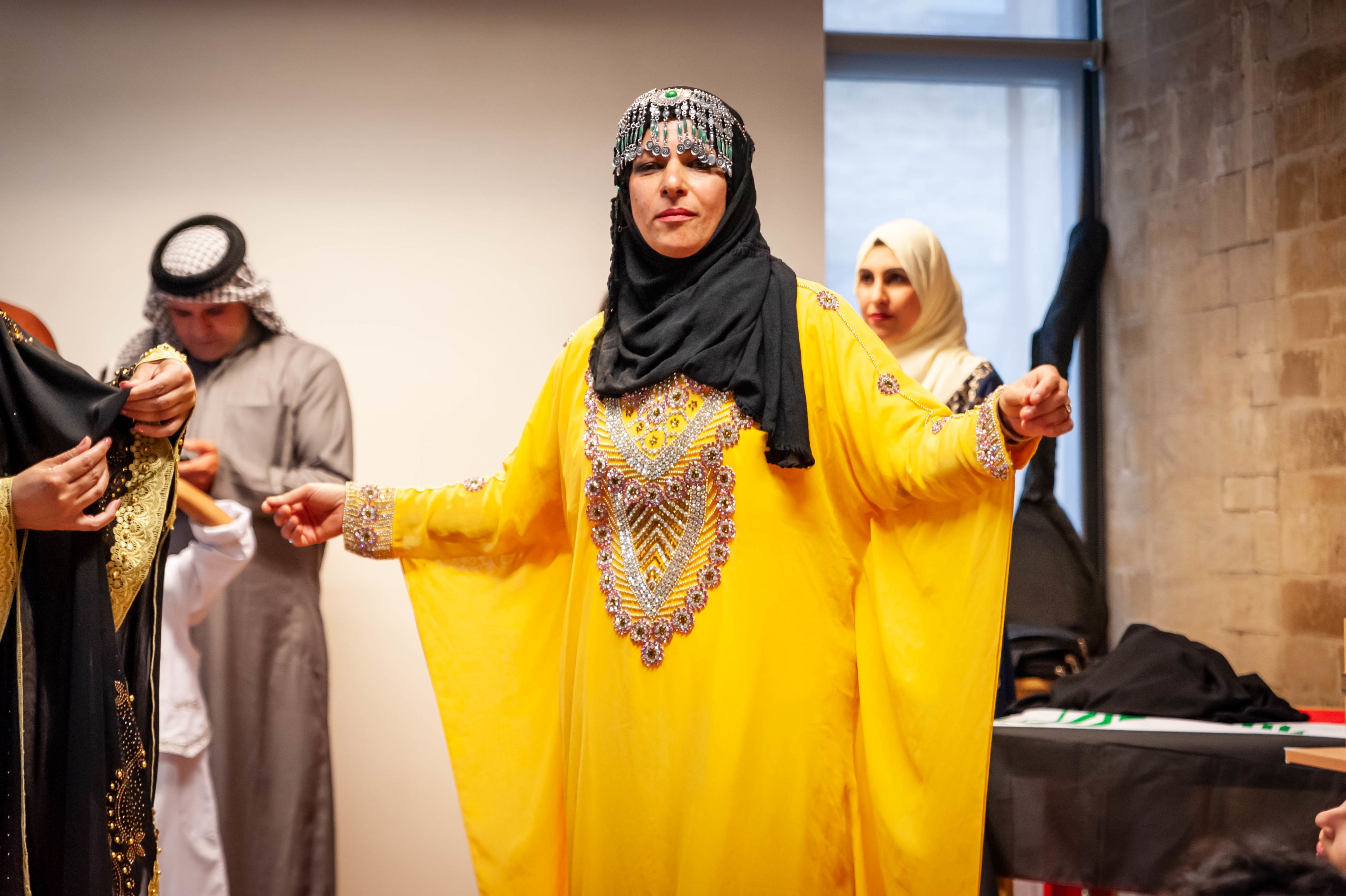 A woman in a traditional costume at a fashion show