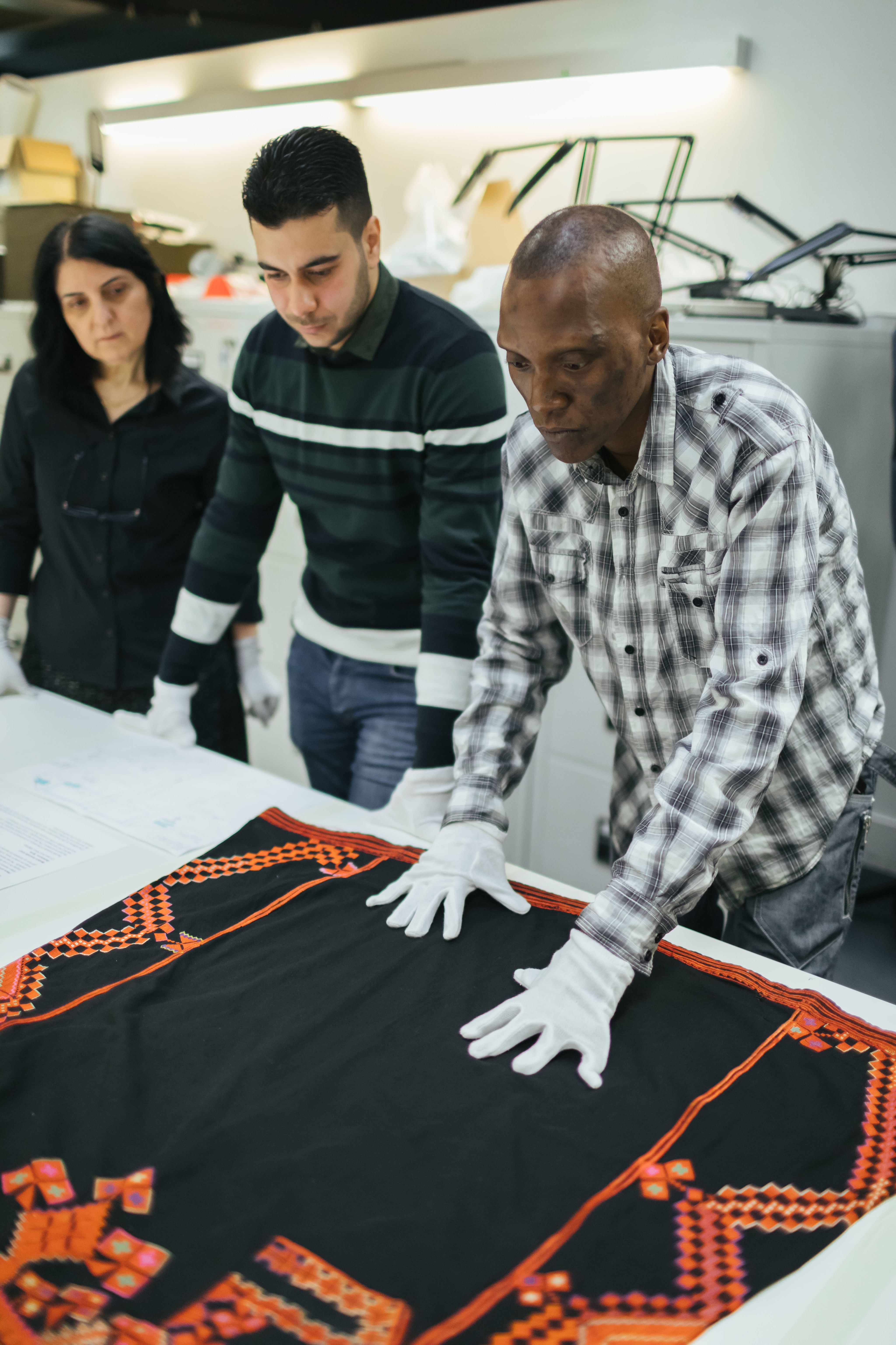 Scientists examining a Syrian dress