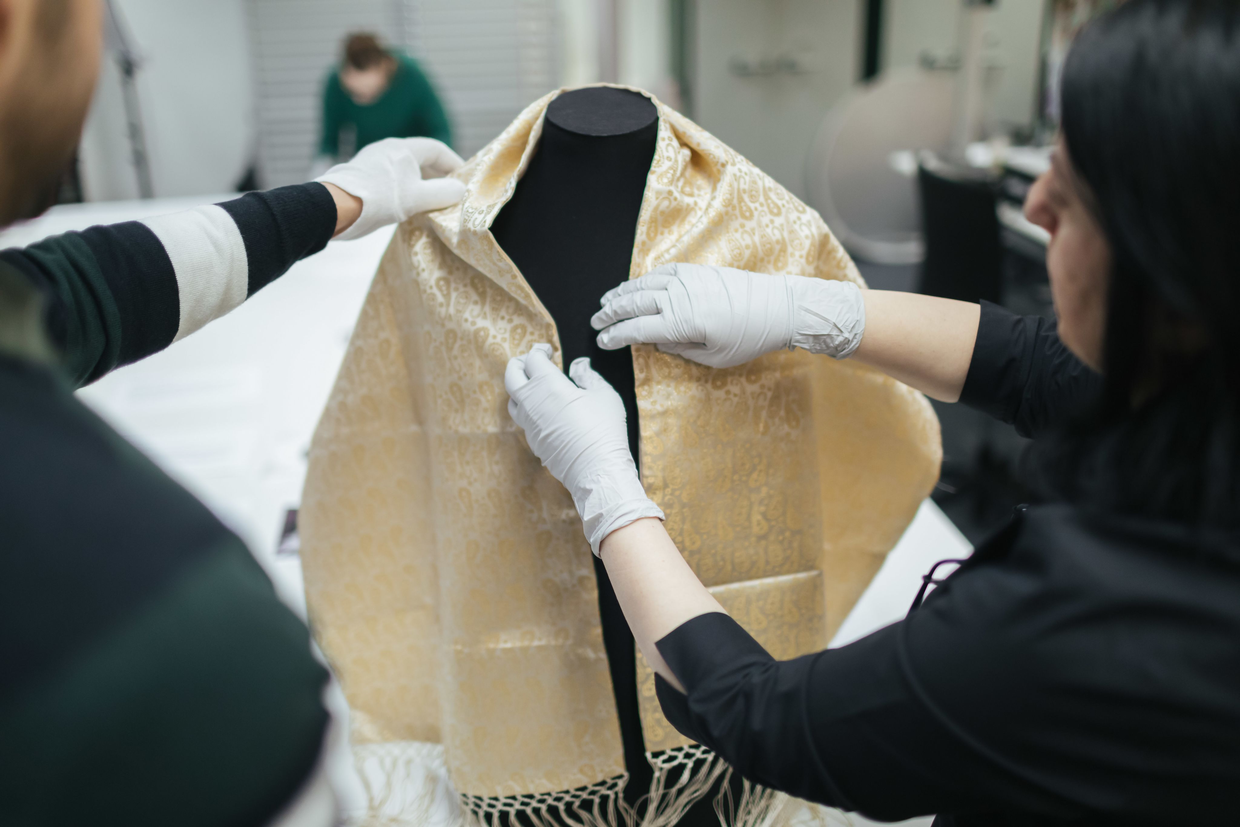 A scarf being prepared for display