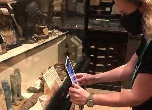 Academic videoing a display of artefacts