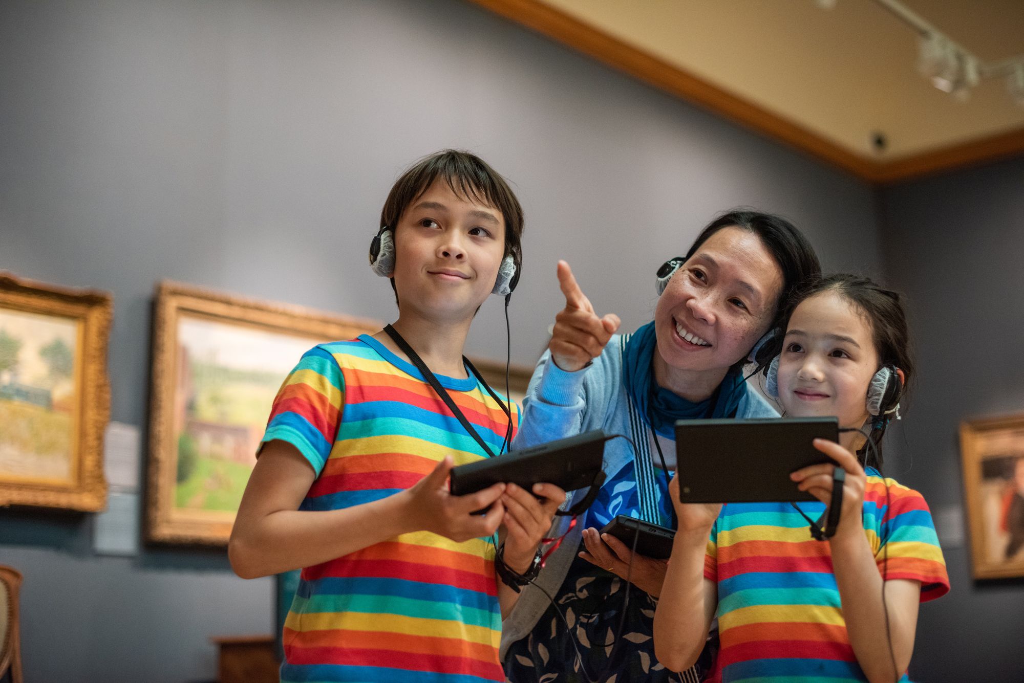 A mother, son and daughter looking at artwork inside the Ashmolean Museum