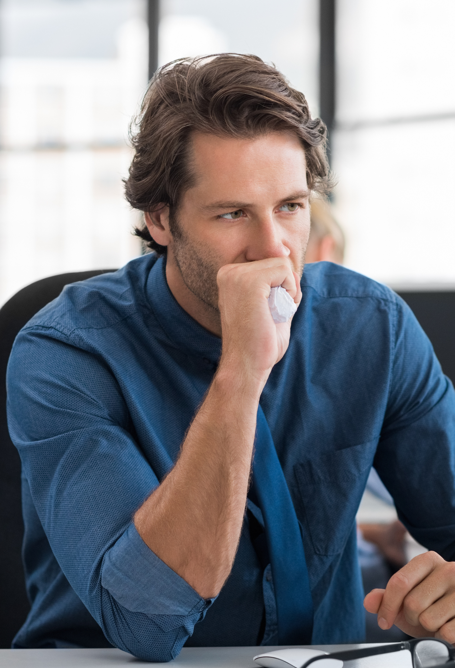 Stressed man sitting at office desk 