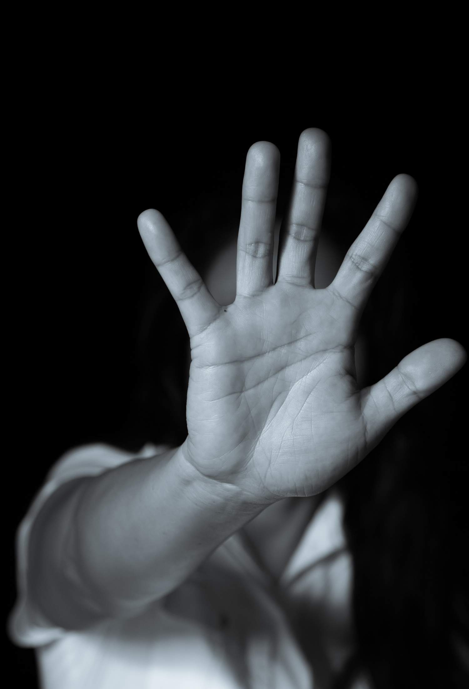 Person holding hand in front of face