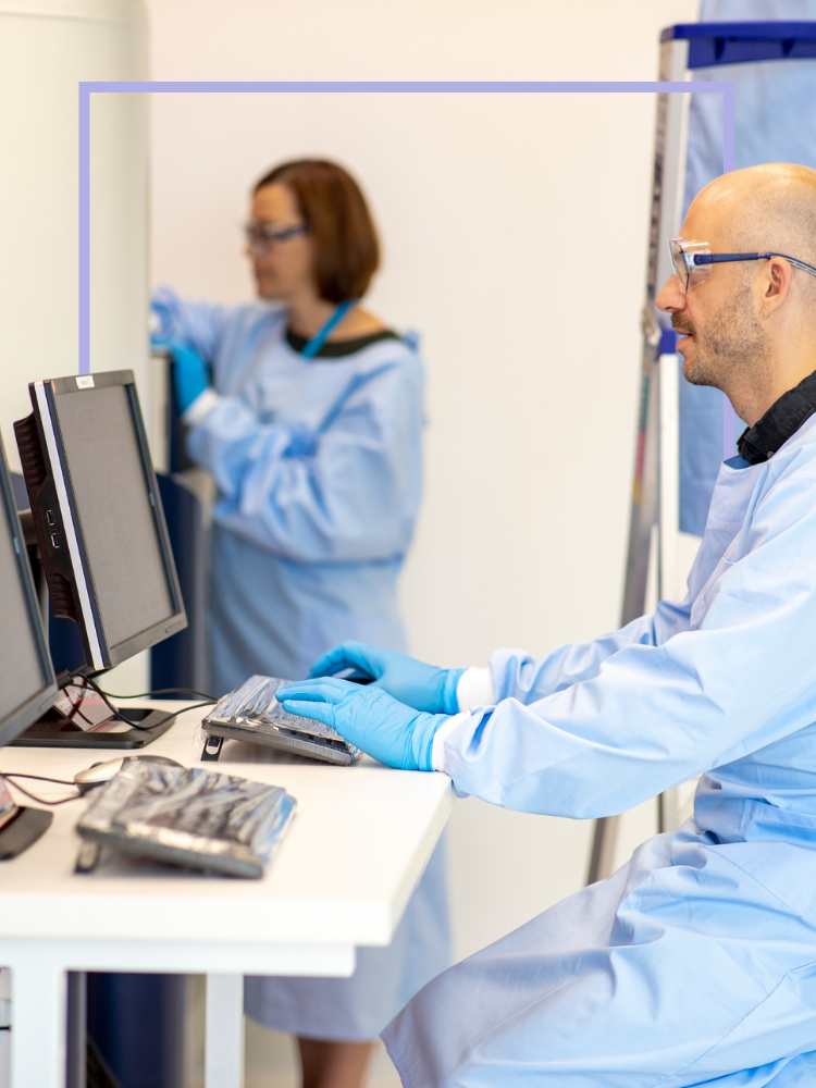 Man in research lab looking at a computer