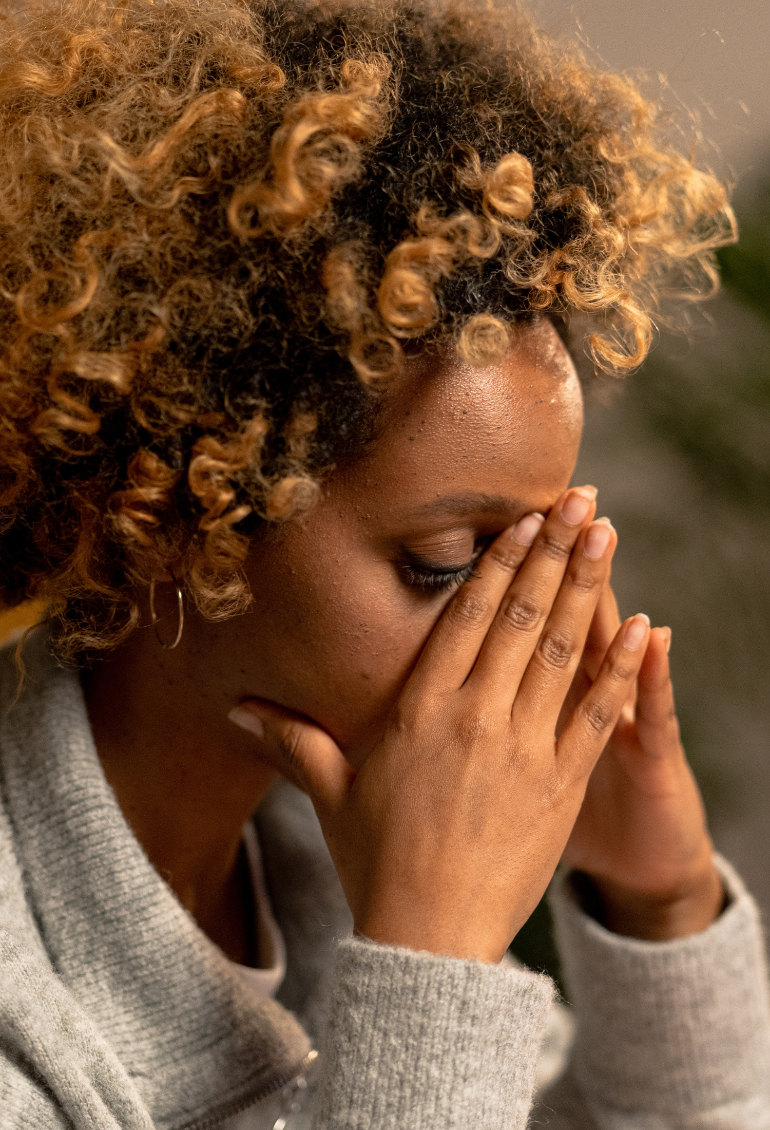 A woman with her hands to her face