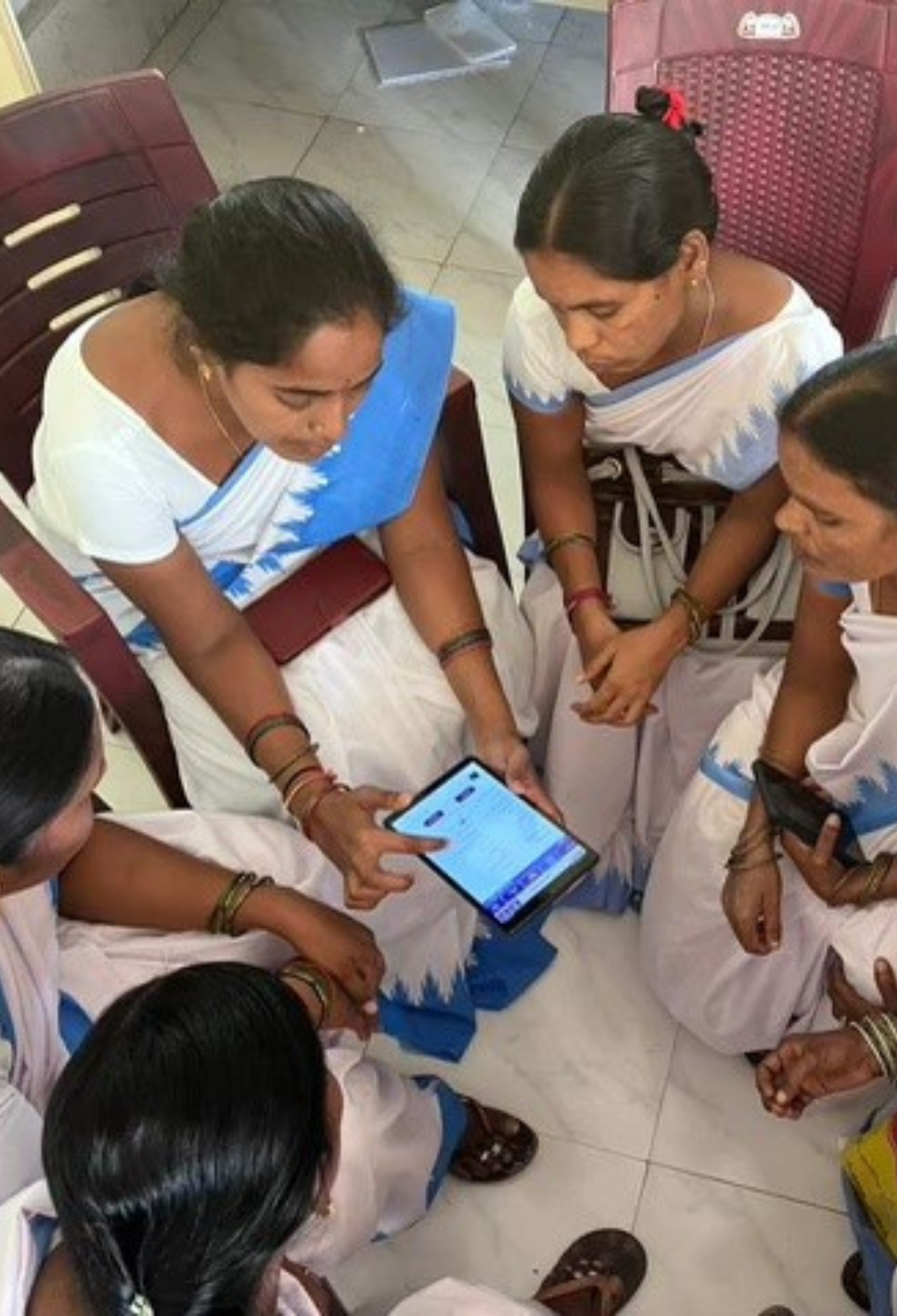 A group of women filling out a survey on a tablet