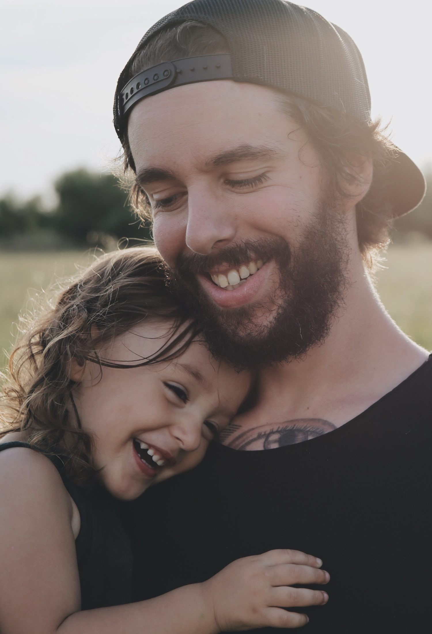 A man hugging a little girl