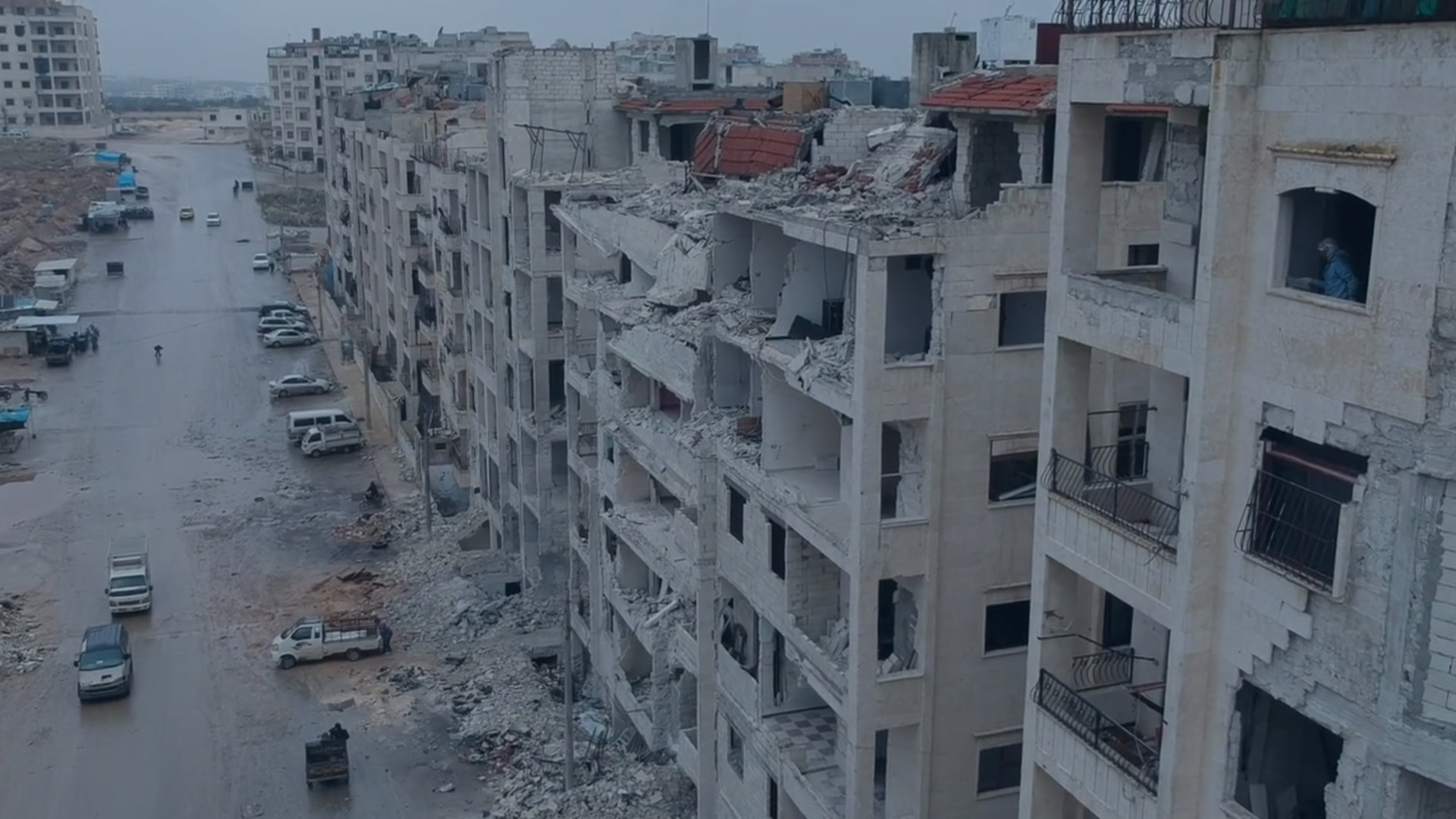 An aerial shot of a street where buildings have been destroyed