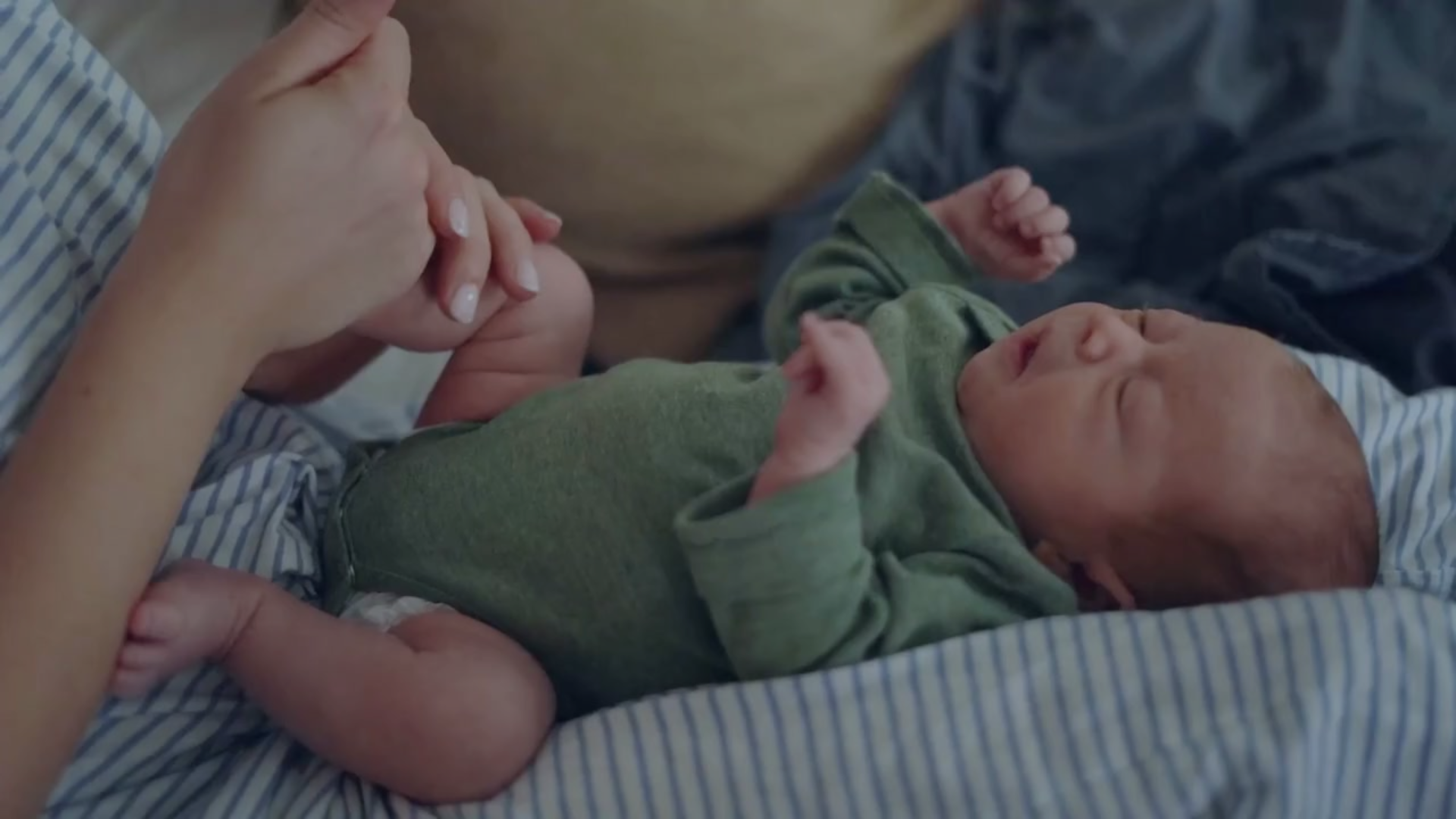 A new mother interacts with a baby
