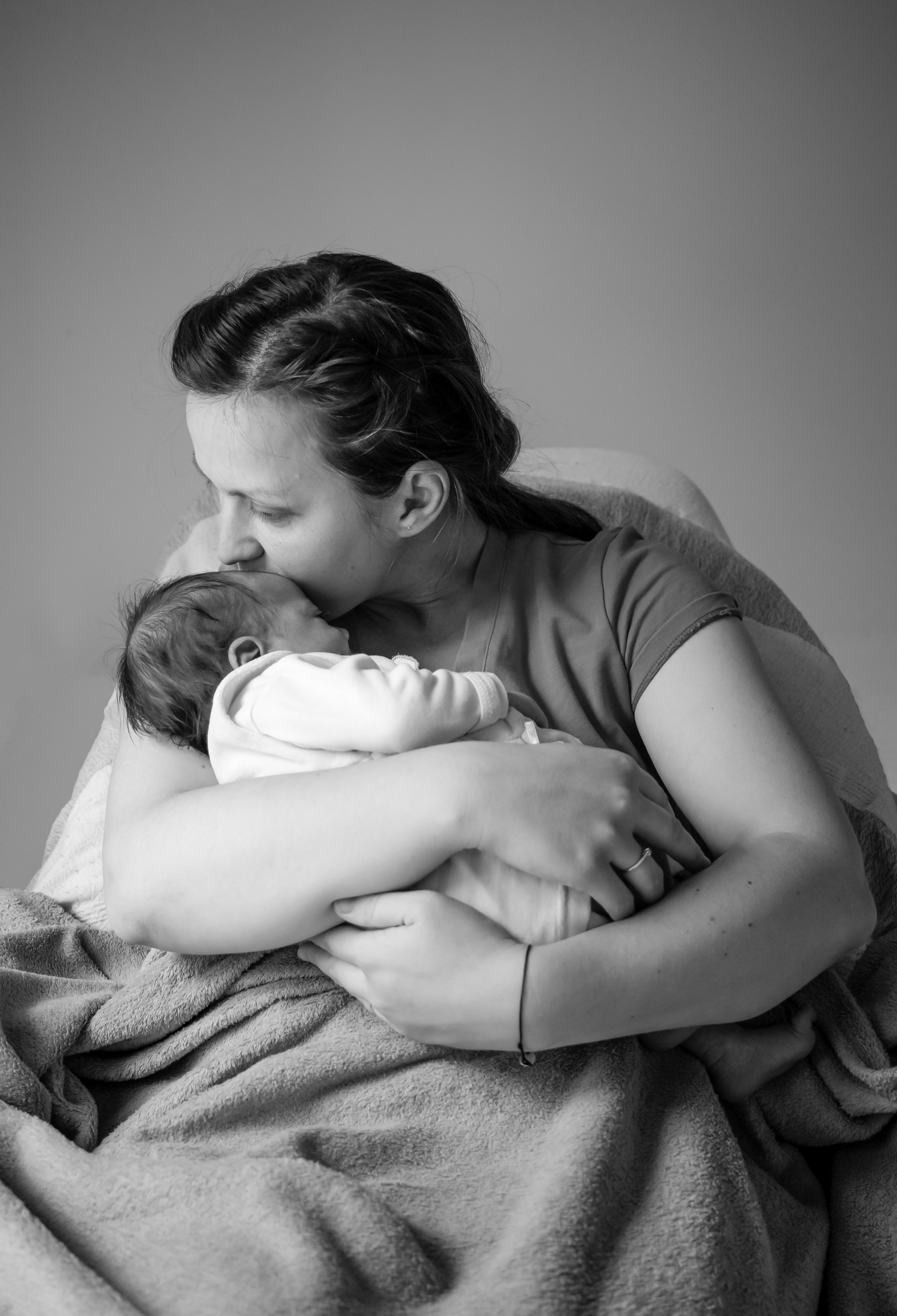 A mother kissing a baby