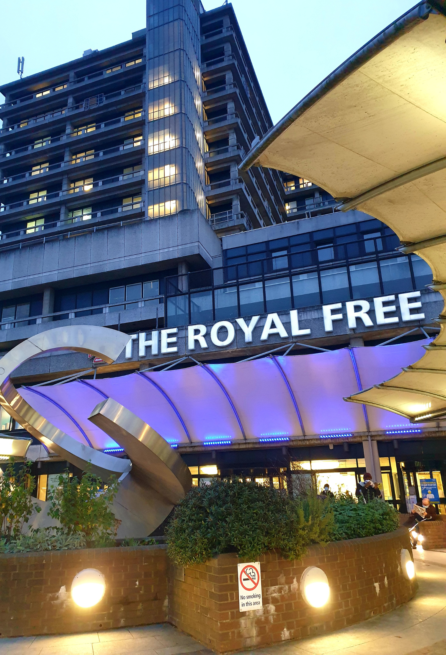 A white sign, lit up reading 'The Royal Free'