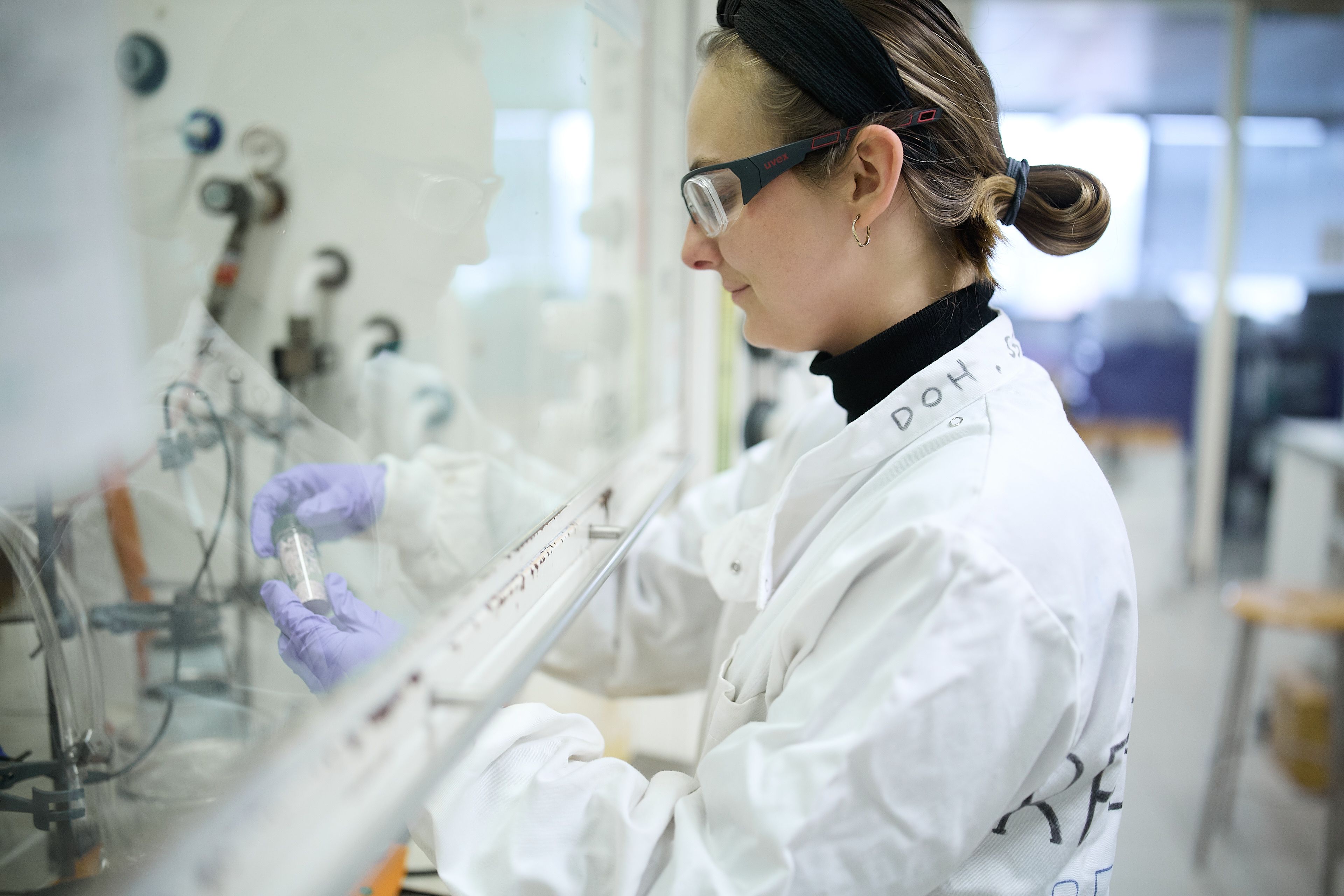 Rebecca Jones looking at test tube