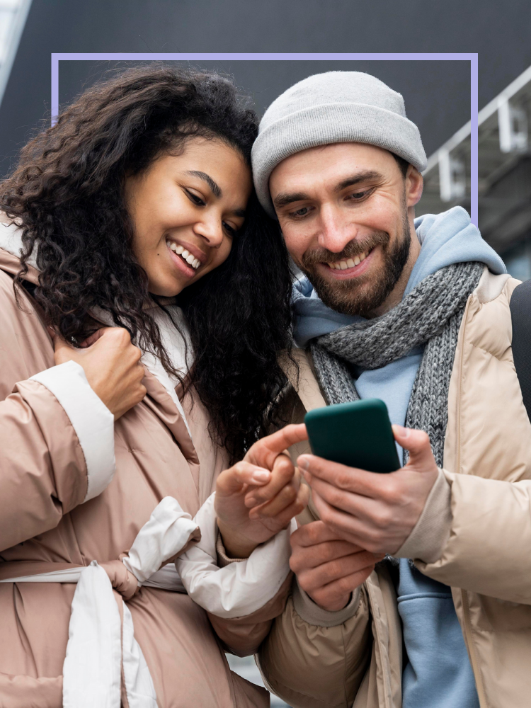 Woman and man looking at phone and smiling